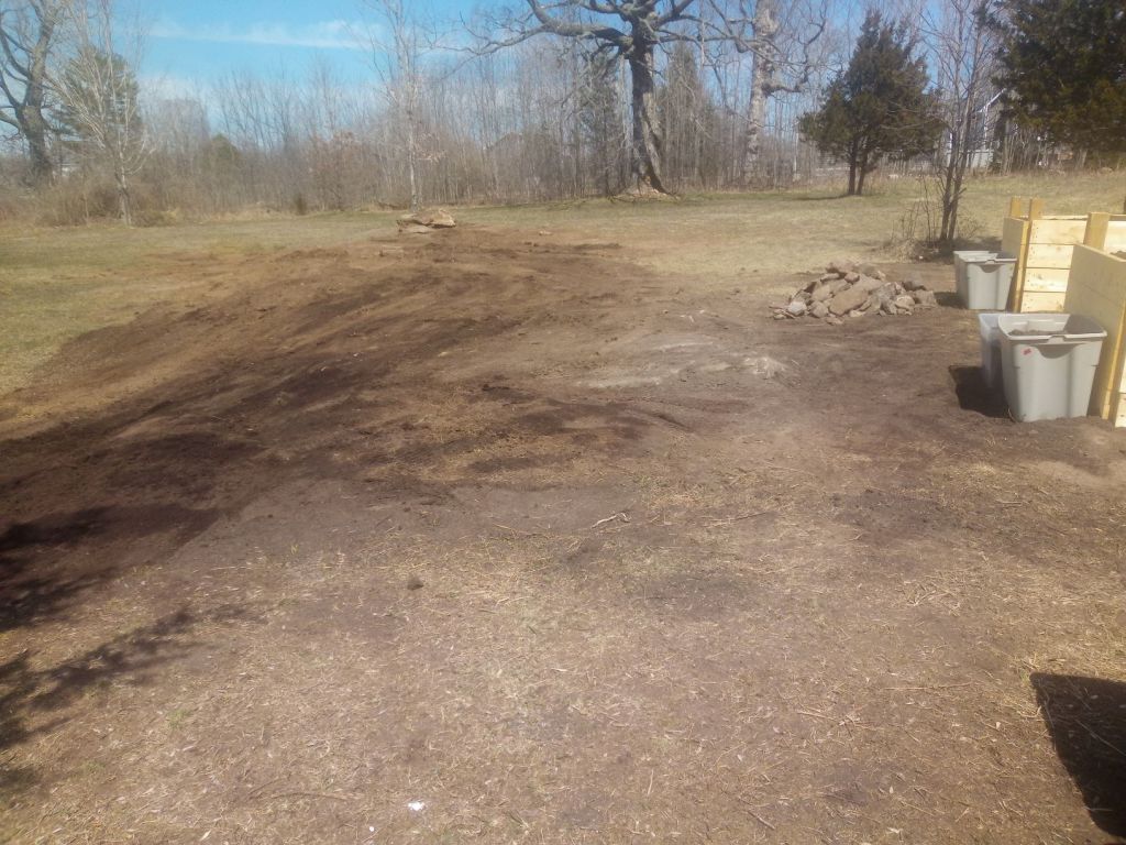 Leveled area of soil beside the garden beds
